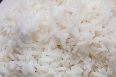 cooked rice on bowl on black background
