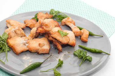 close up of grilled chicken breast on plate