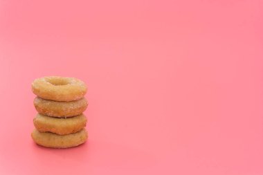 Fried Donuts with sugar topping on pink background