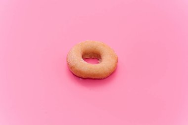 Fried Donuts with sugar topping on pink background