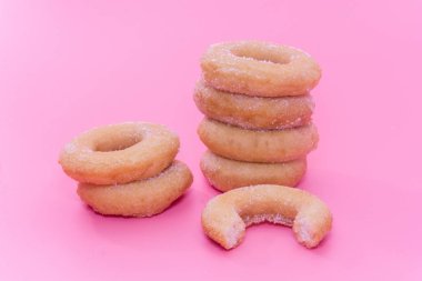 Fried Donuts with sugar topping on pink background
