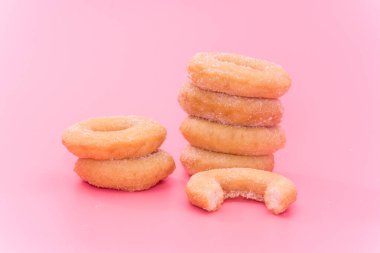 Fried Donuts with sugar topping on pink background