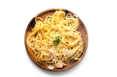 spaghetti carbonara with cream on wooden plate on white backgrou