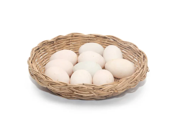 Raw dirty duck eggs in basket on white background — ストック写真