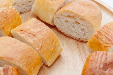 a slice of french bread on wooden plate