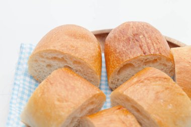 a slice of french bread on wooden plate