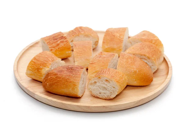A slice of french bread on wooden plate — Stock Photo, Image