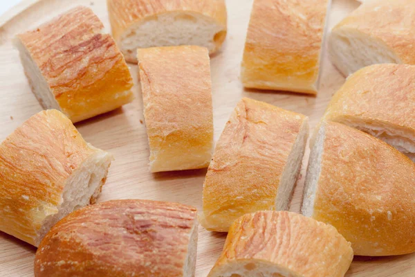 A slice of french bread on wooden plate — 스톡 사진