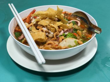 close up of Spicy TOM YAM seafood noodle soup