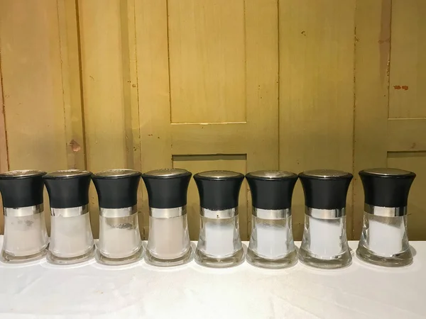 Row of salt glass jar on the table — Stockfoto