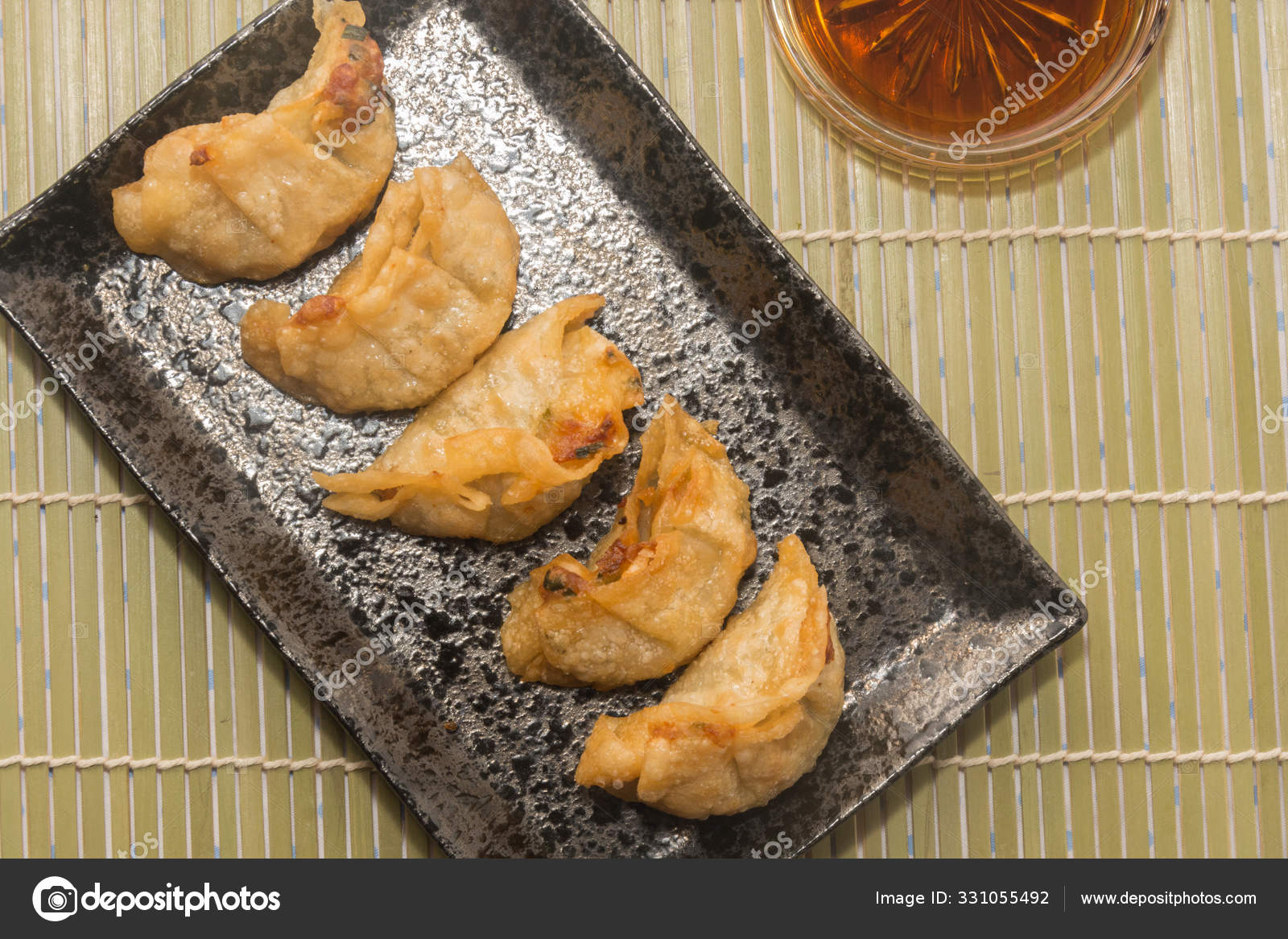 Fried Pork Gyoza Dumplings On Black Plate Stock Photo C Moxumbic