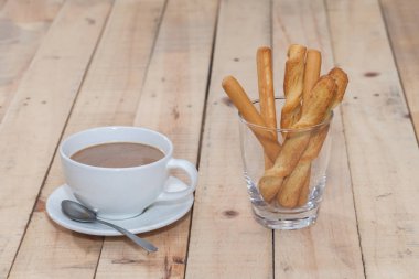 salted bread stick and cup of coffee