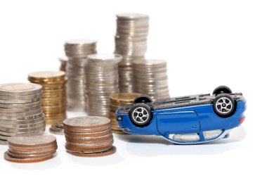accident of toy car and stack of coin isolated on white backgrou