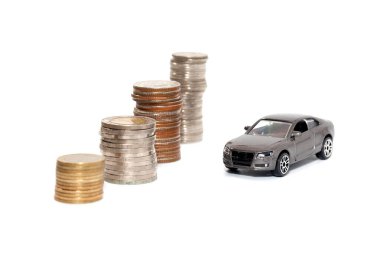 toy car and stack of coin isolated on white background