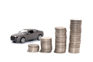 toy car and stack of coin isolated on white background