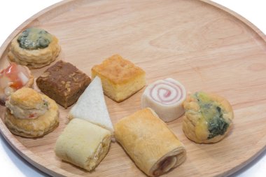 a variety of bakery on wooden plate