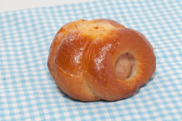 Close up of chicken sausage bun on fabric — 스톡 사진