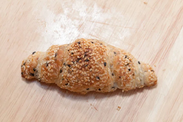 close up of sesame croissant on plate