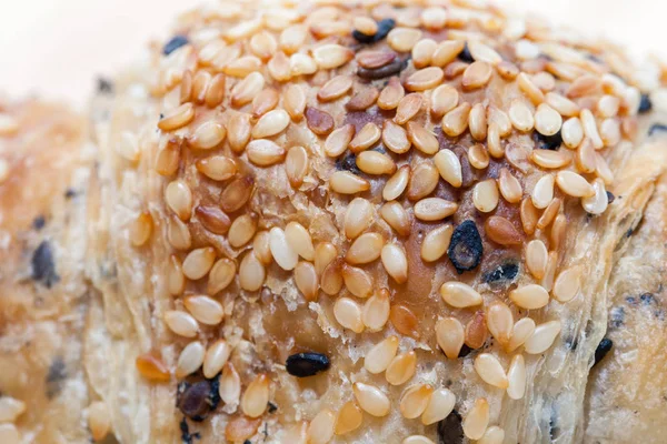 close up of sesame croissant on plate