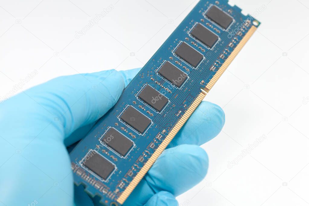 hand in blue glove holding ram memory on white background
