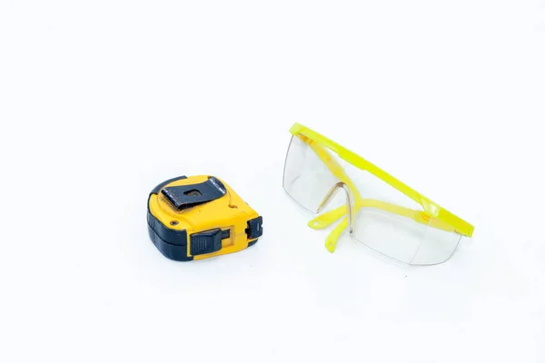 Measuring Tape and Safety Glasses protection on white background — Stock Photo, Image