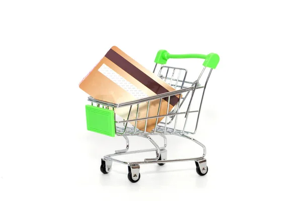 Mini shopping cart with credit card on white background — Stock Photo, Image