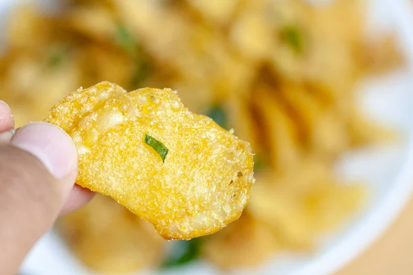 close up of salted egg potato chips on plate