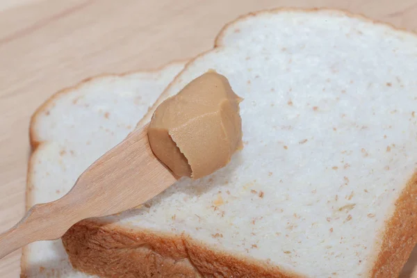 Peanut butter sandwich bread on wooden plate — Stock Photo, Image