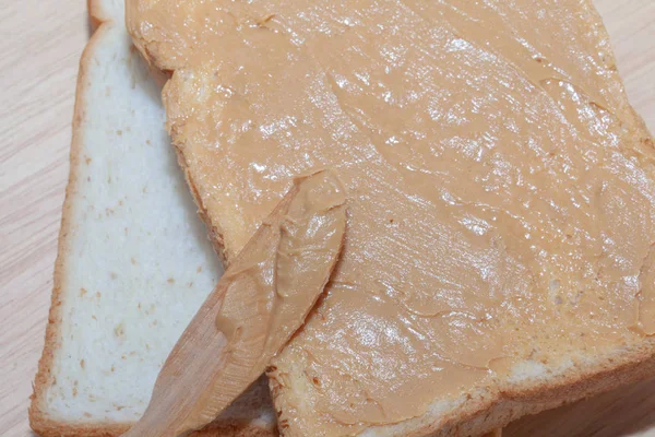 Сэндвич с арахисовым маслом на деревянной тарелке — стоковое фото