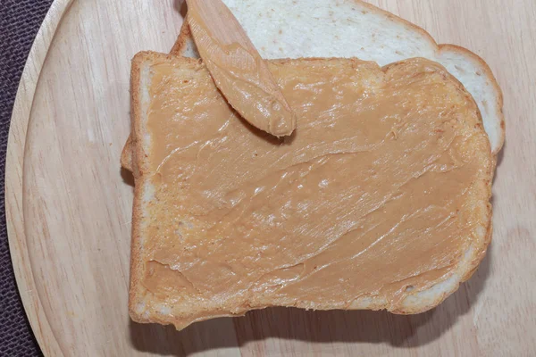Pão de sanduíche de manteiga de amendoim em placa de madeira — Fotografia de Stock