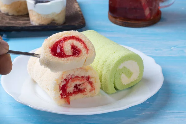 pandan swiss roll cake and strawberry swiss roll cake