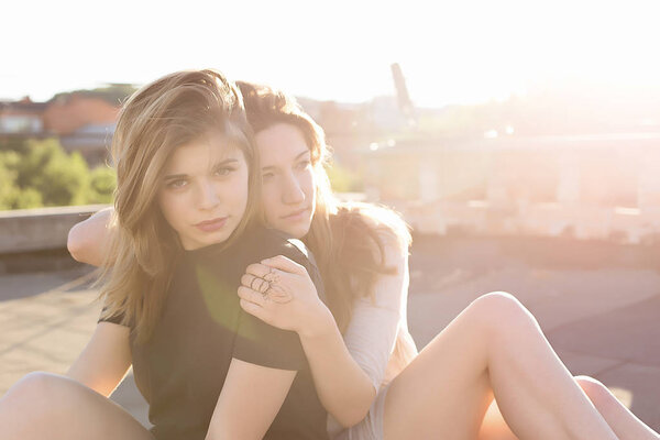Portrait of two girlfriends on the roof 