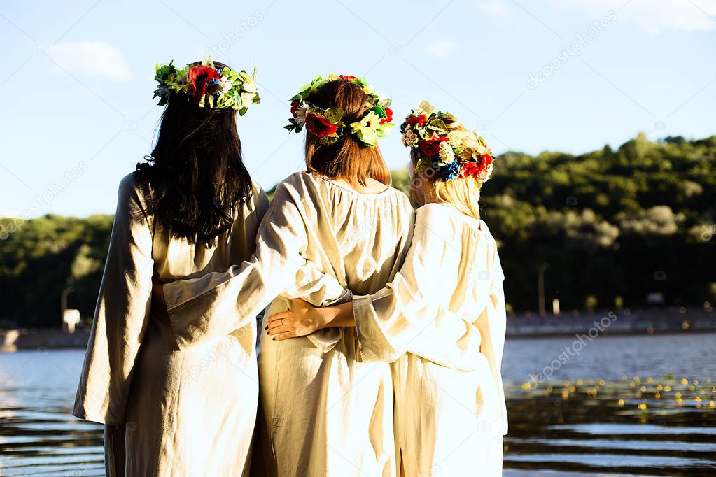 Girls in ethnic clothes with wreath of flowers celebrating