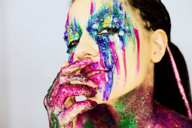 Yakın çekim yaratıcı glitter ile güzel bir kızın portresi makyaj