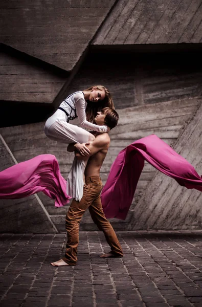 Couple de jeunes danseurs passionnés exécutant une routine de danse ensemble dans la rue — Photo