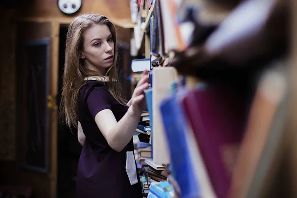 Retrato de estilo de vida de una encantadora estudiante en una biblioteca o librería vintage —  Fotos de Stock