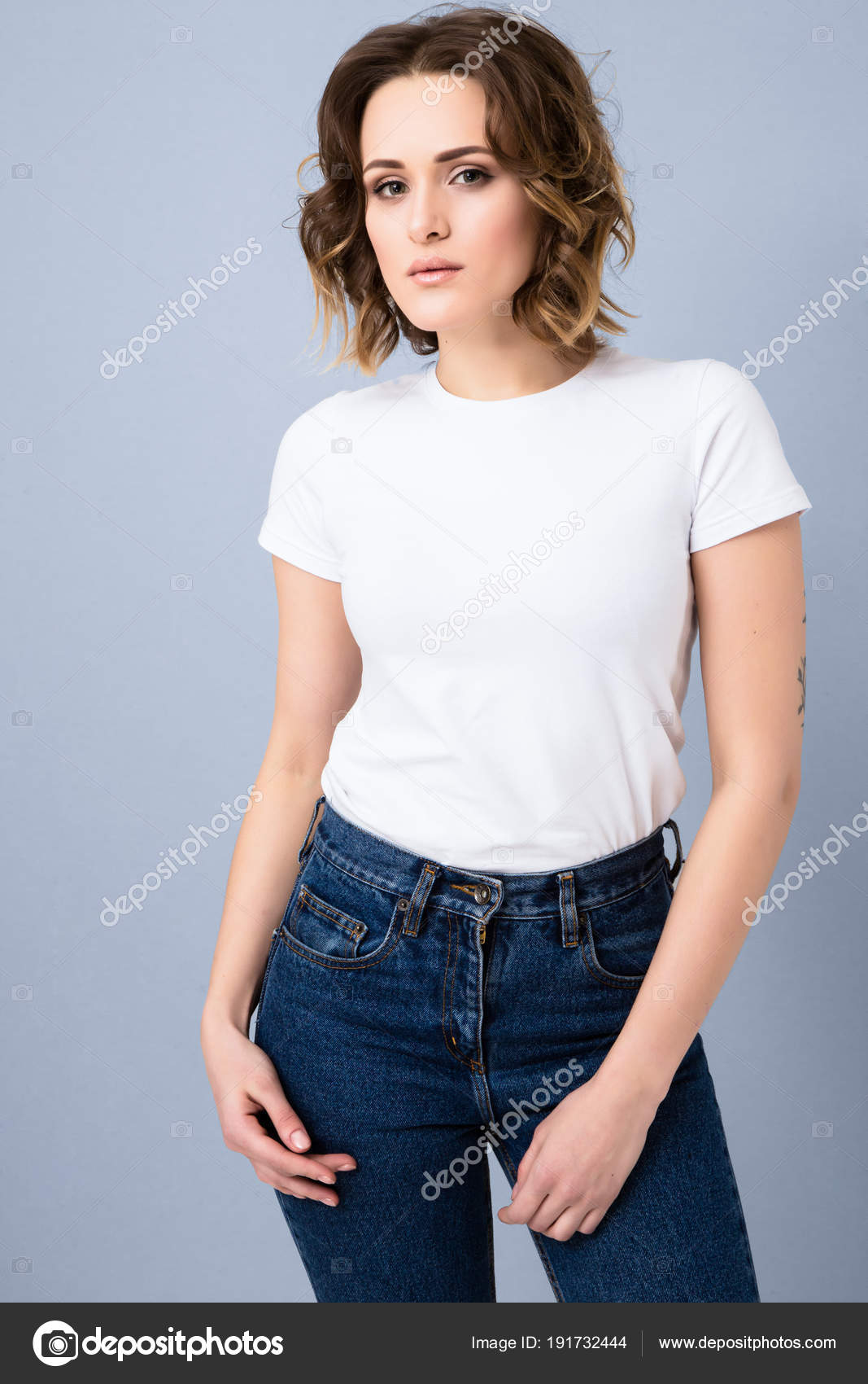 Young stylish beautiful woman wearing blue shirt, blue denim jeans