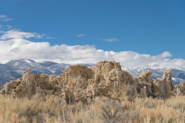 Mounds of the natural formation of tufa with the Sierra Nevada mountains in the background at Mono Lake in California, USA clipart