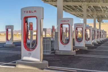 BAKER, USA - FEBRUARY 16, 2018: Tesla Supercharger charging station for recharging electric vehicles at Baker in southern California  clipart