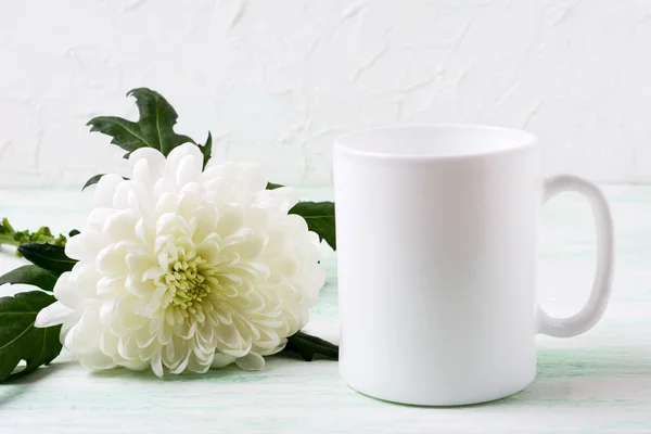 White coffee mug mockup with chrysanthemum