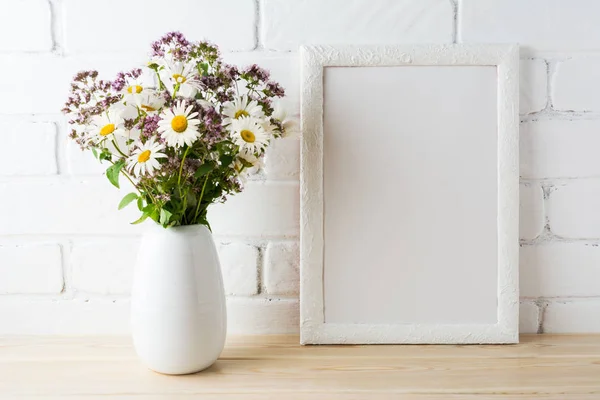 White frame mockup with blooming wildflower bouquet near painted