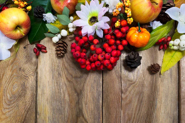 Fall decoration with pumpkin, apples, autumn leaves and rowan be
