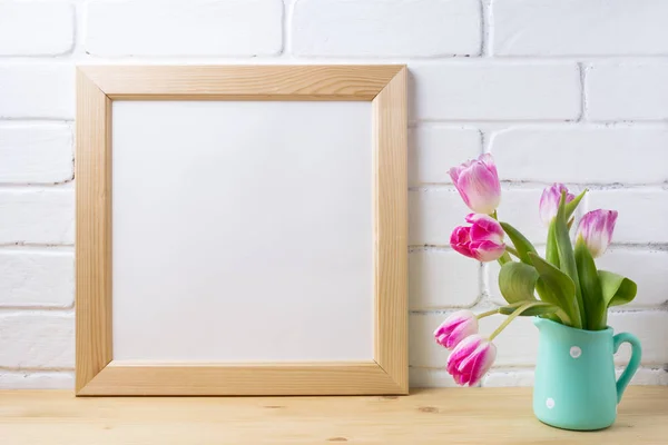 Wooden square frame mockup with pink tulip in mint pitcher vase