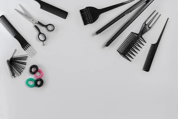 Hairdresser set with various accessories on gray background — Stock Photo, Image