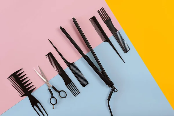 Verschillende haar styling apparaten op de kleur blauw, geel, roze achtergrond papier, bovenaanzicht — Stockfoto