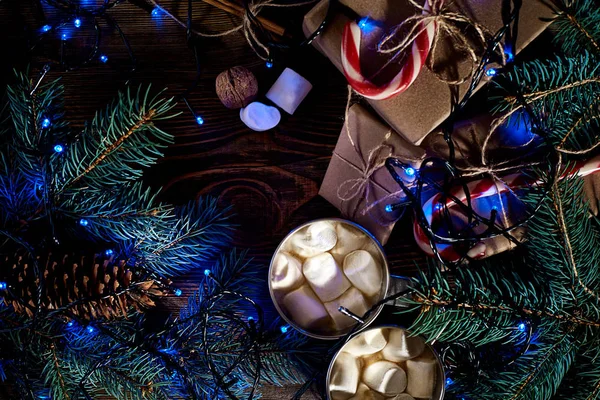 Christmas wooden background with fir tree. Christmas tree branch with decorations on wood background and garland. — Stock Photo, Image