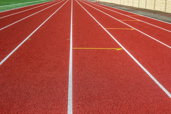 Red treadmill in sport field.