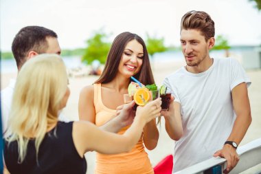 Arkadaşlar eğlenmeye barda kokteyller açık havada, içme.