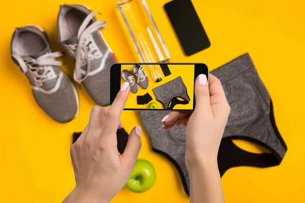 Equipo deportivo fotografiando en el teléfono móvil. Pantalla Smartphone con herramientas de fitness imagen — Foto de Stock