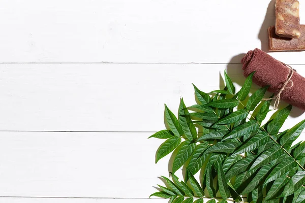 Kahverengi havlu ve doğal kahve soap üzerinde beyaz ahşap masa, üstten görünüm